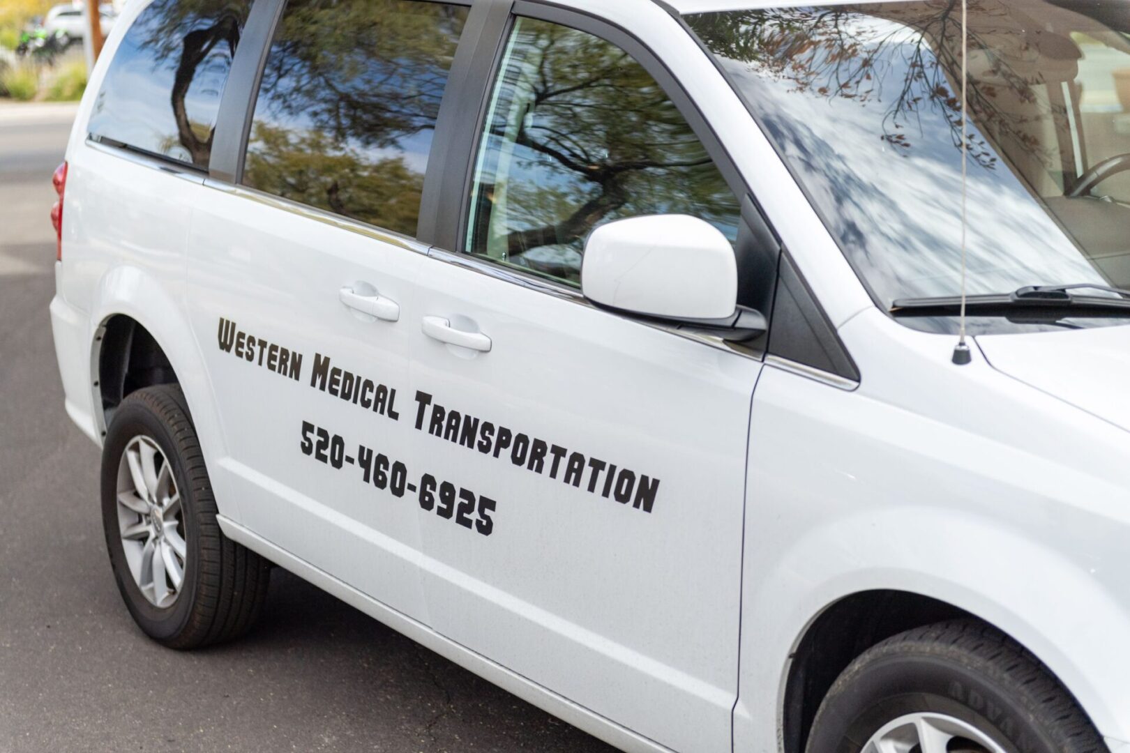 A white van with the words western medical transportation on it.