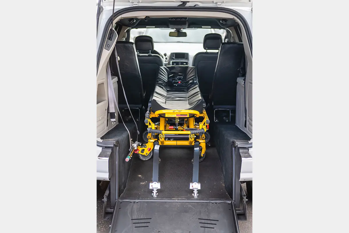 A wheelchair lift in the back of an ambulance.